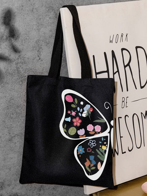 Black canvas tote bag with colorful butterfly design