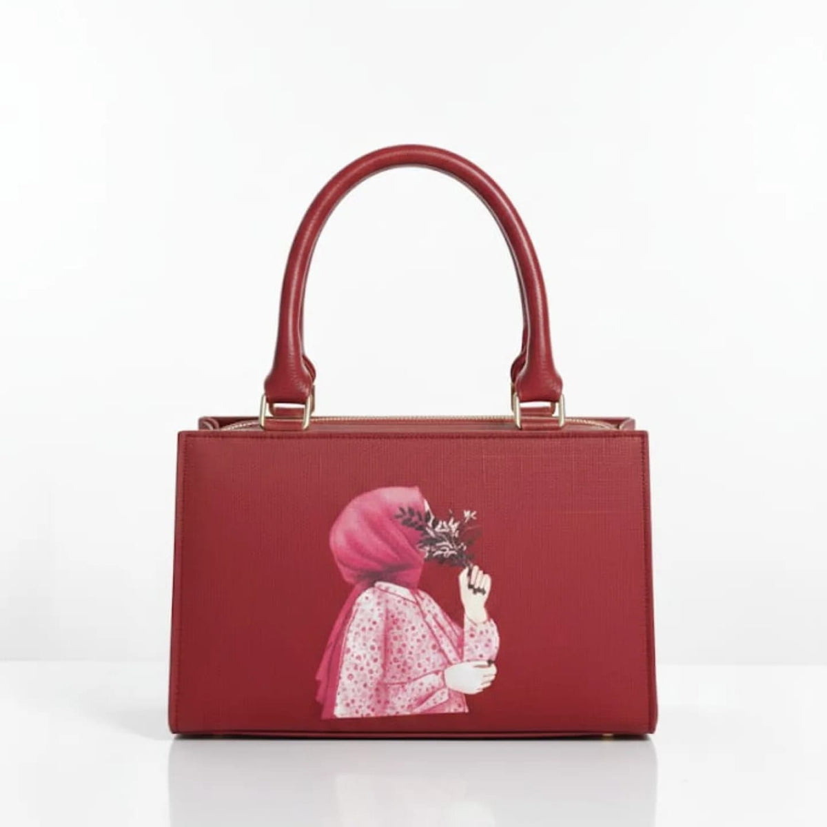 Red structured top-handle handbag with illustrated front panel and gold-tone hardware