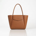 Tan textured tote bag with long handles and front flap pocket